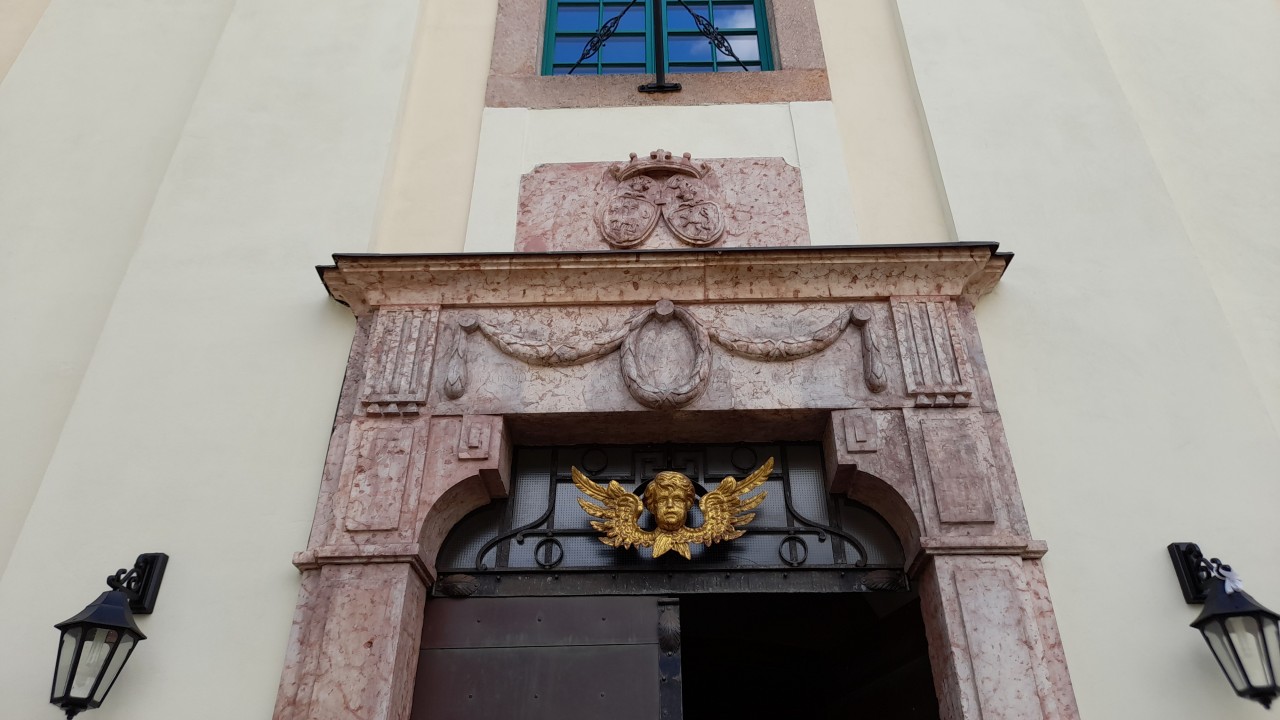 A templomkapu felett két címer látható. Kiknek a címerei ezek?